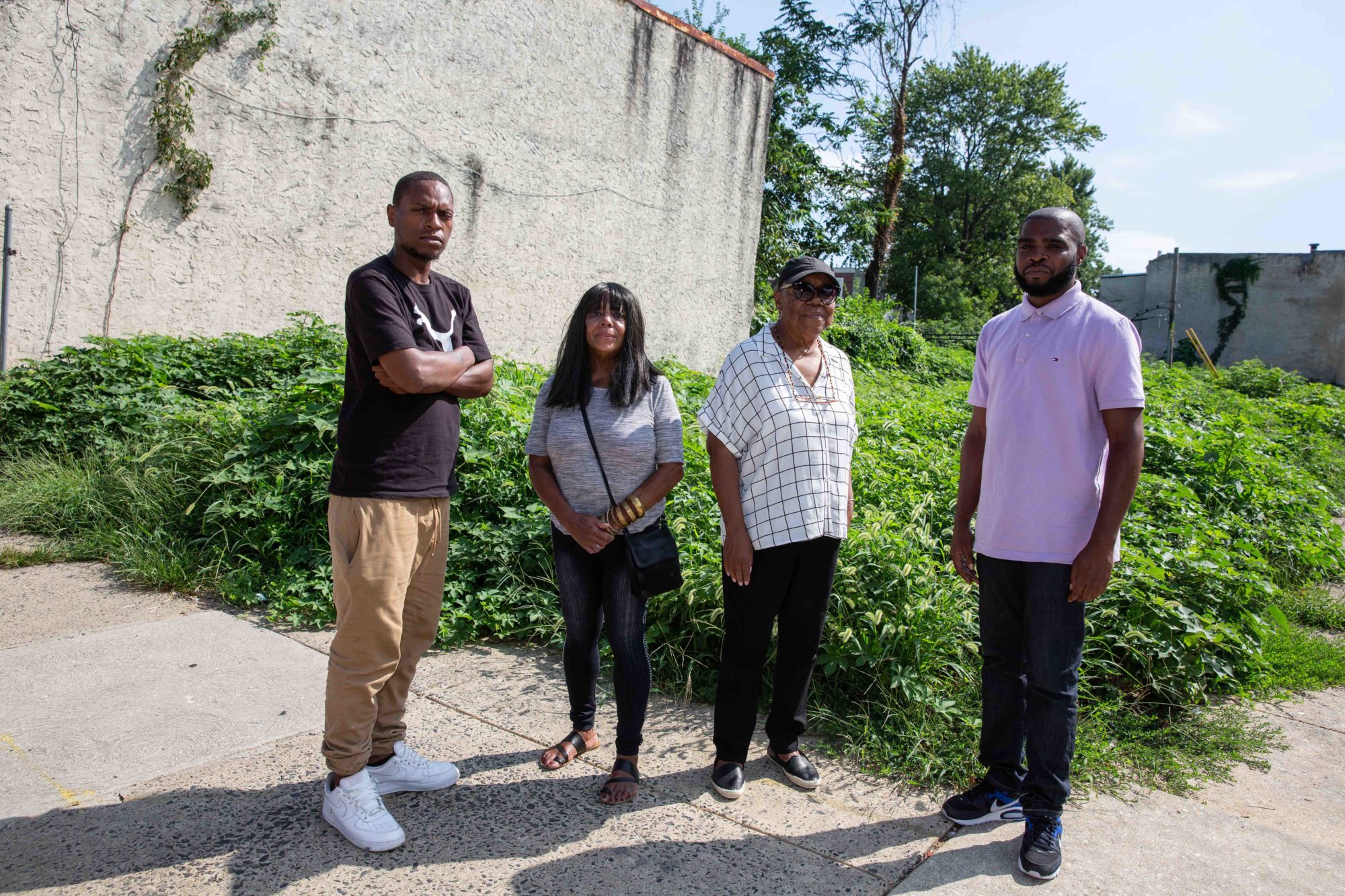 Mantua community members Nathaniel Mitchell, Camille Marion, Gwen Morris and De’Wayne Drummond stand in front of the lot at 38th and Melon streets where the first Park in a Truck will be built in October.