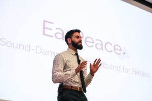 Student pitches his product EarPeace on stage