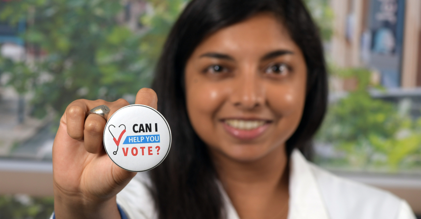 Alisha Maity holding up a voting button