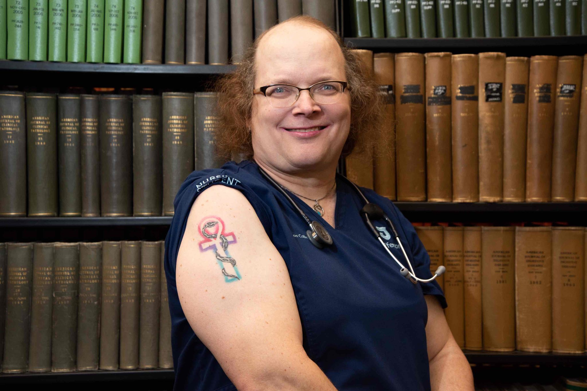 Jennifer Booker got a tattoo of her Burmese python, Fluffy, on the Rod of Asclepius, combined with the Egyptian ankh—the symbol of life.