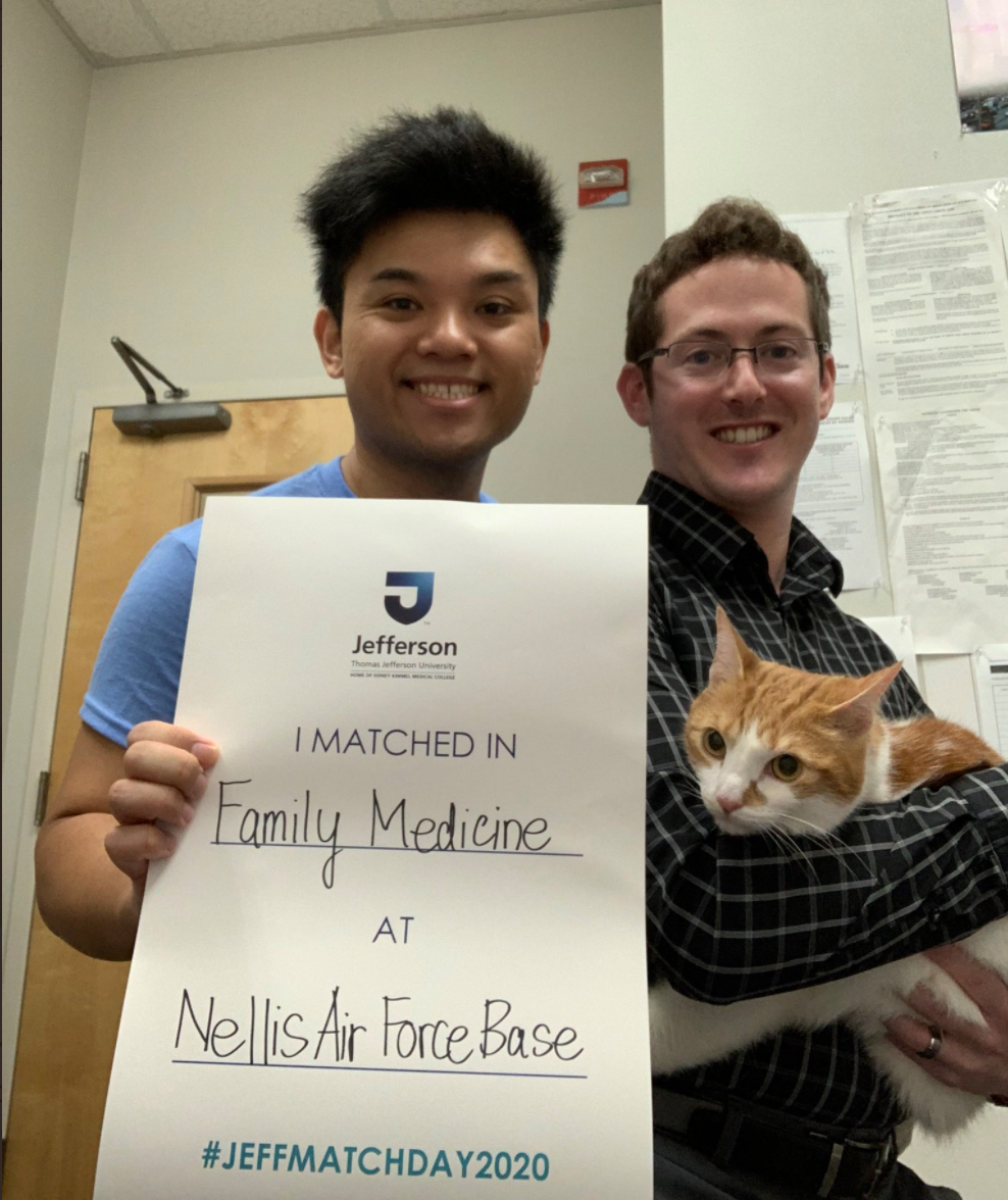 Medical student holds a match day sign