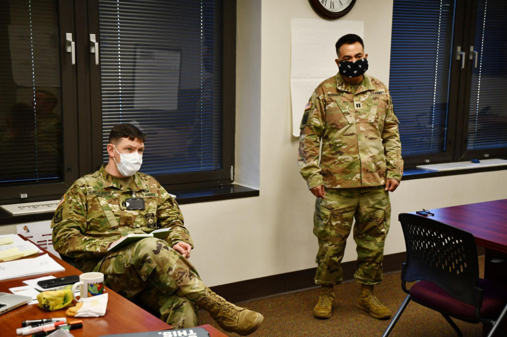 Capt. Honsberger in military fatigues and mask