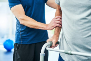 A physical therapist working with a patient