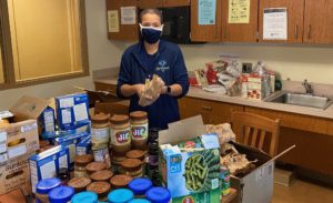 Population health student Sarah Modlin helps make care packages for Thanksgiving.