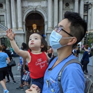 Xiao Chi Zhang, holding his daughter Delia, in front of Philadelphia's City Hall.